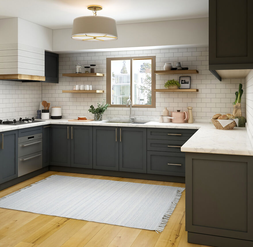 Grey kitchen cabinets with modern hardware, white marble countertops, open wooden shelves, and a large white grey rug.