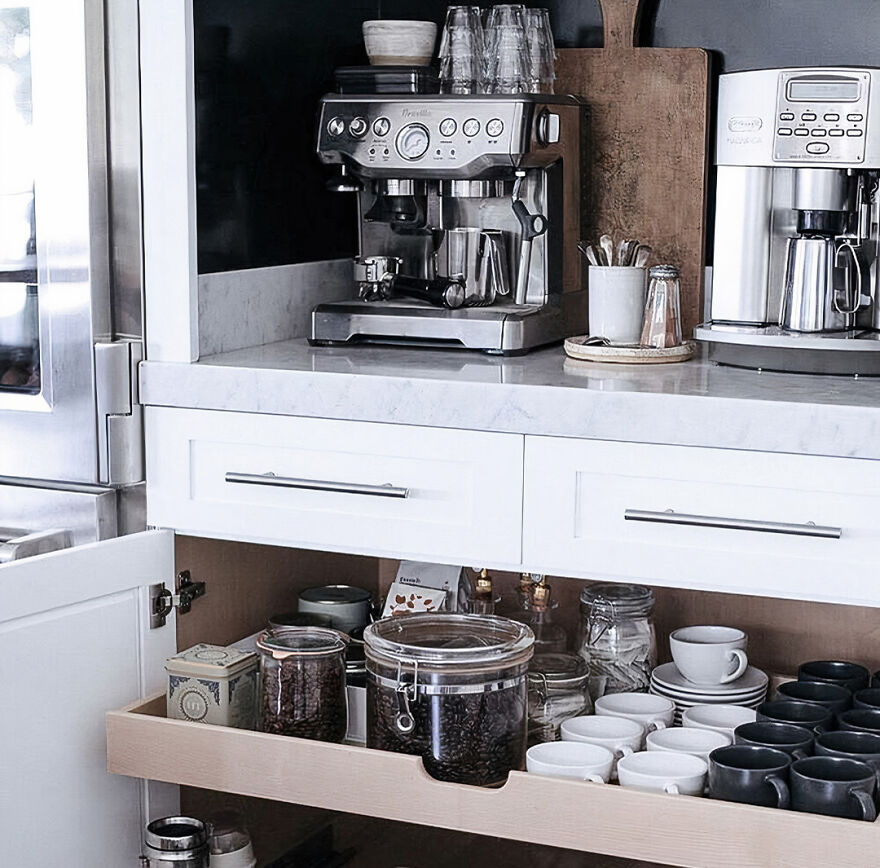 Modern kitchen cabinets with a metal coffee machine and organized coffee appliances for a stylish renovation inspiration.