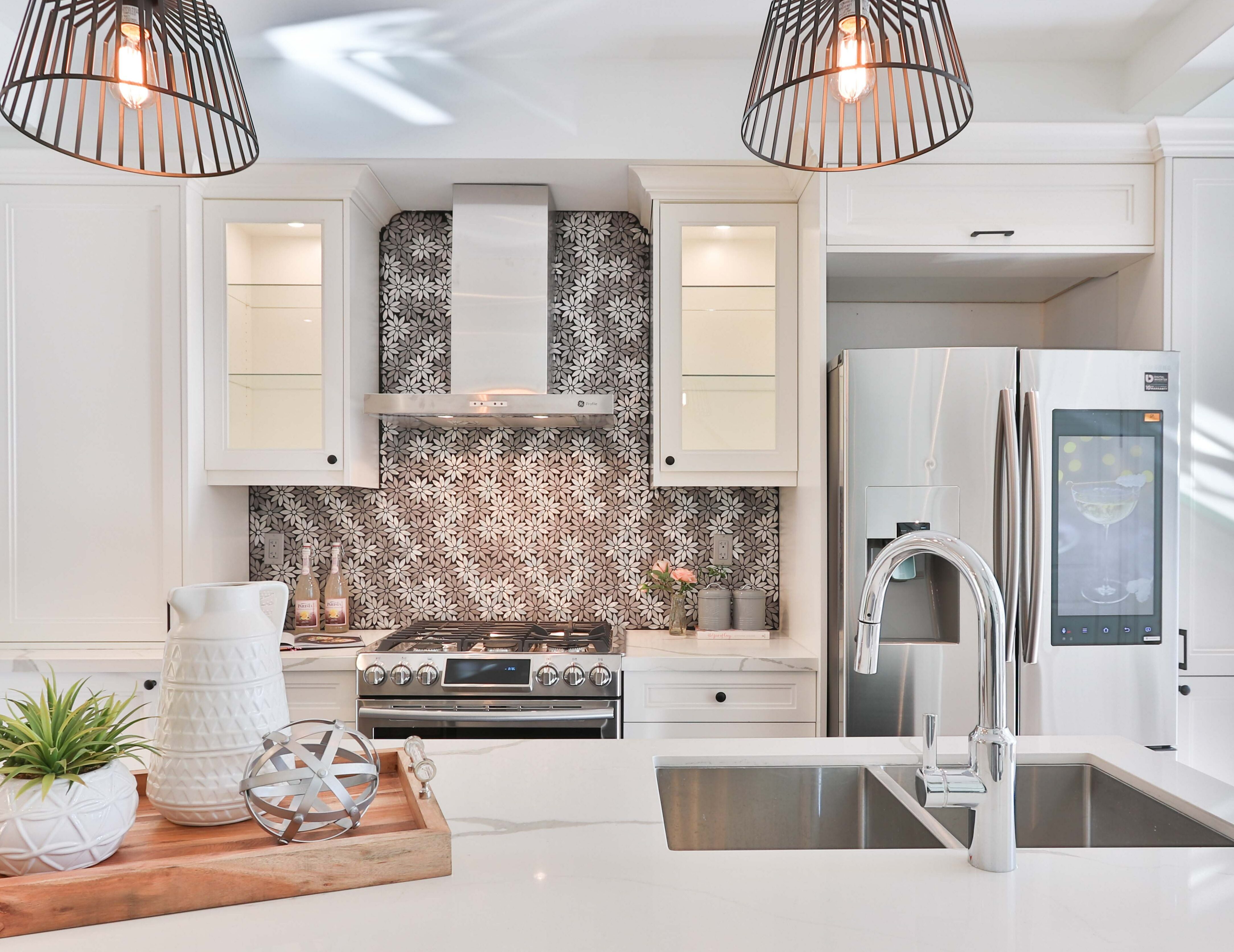 Kitchen with flower pattern wallpaper and white cupboards