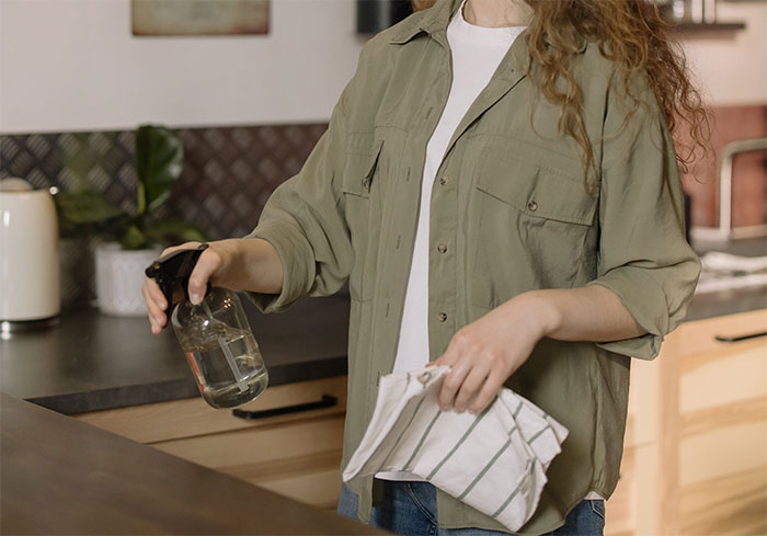 Woman cleaning countertop Woman cleaning countertop