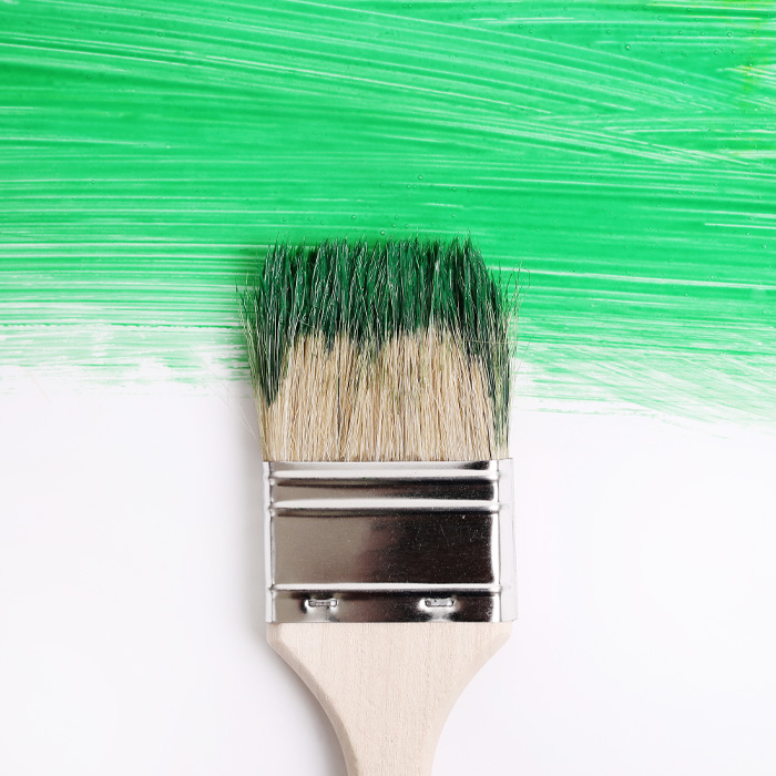 A brush between yellow and white parts of the wall