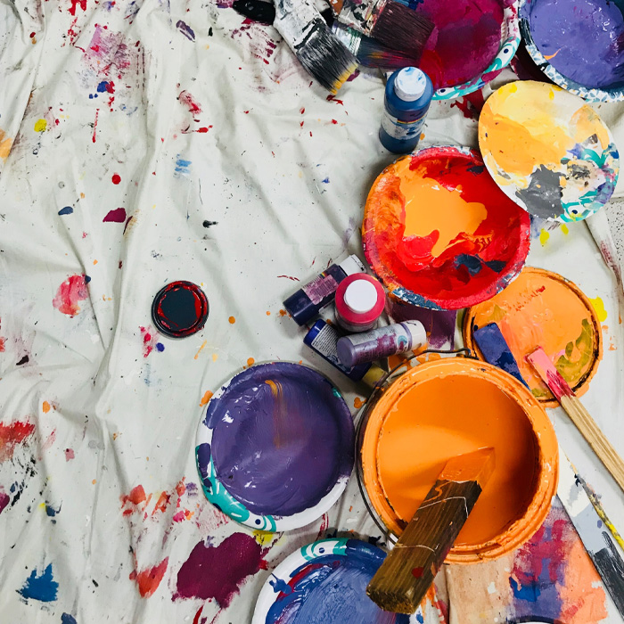 Assorted-color paints and paintbrushes