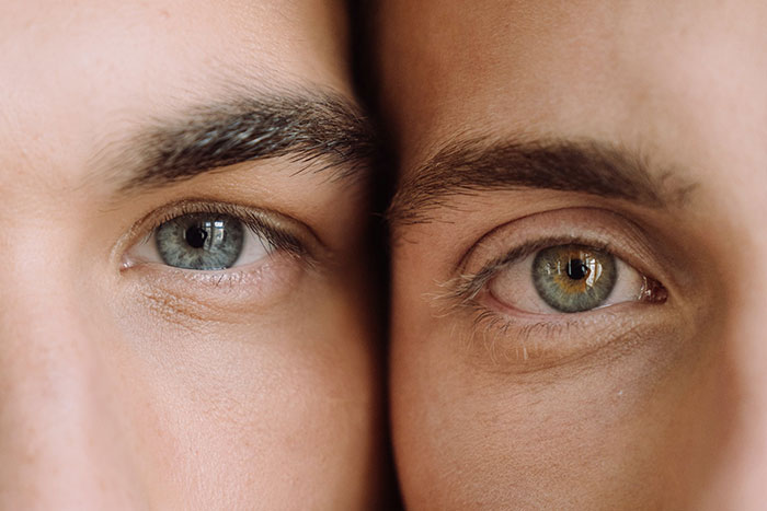 Close-up of two human eyes with different colors, illustrating creepy facts about the world and human diversity.