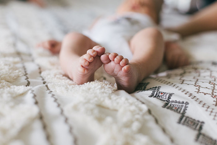 Close-up of a baby's feet resting on a textured blanket, illustrating one of the creepy facts about the world.