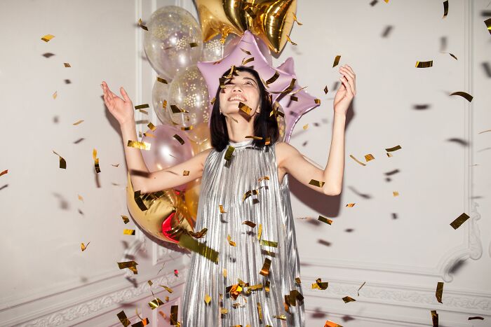 Woman celebrating birthday with confetti 