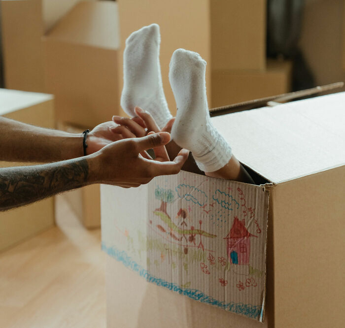 One person tickling legs of another person 