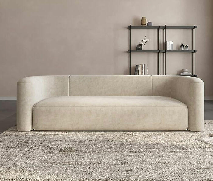 Acanva small couch in neutral tones placed in a minimalist living room maximizing space with stylish lounge furniture.