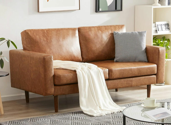 Kingfun small faux leather couch in modern living room, perfect for maximizing your space with stylish lounge seating.