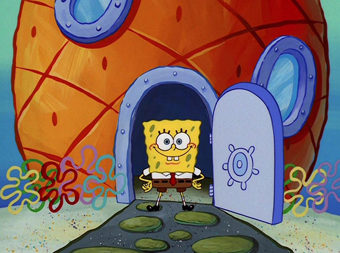 Sponge bob standing in front of his house 