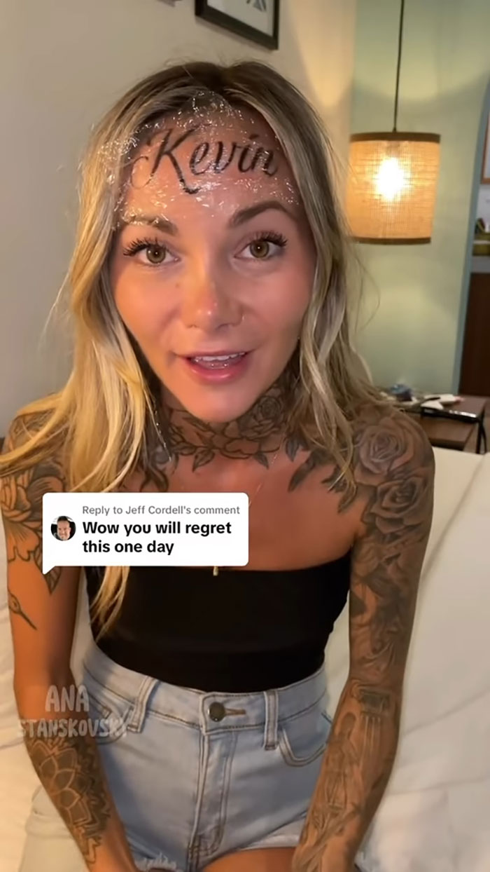 Influencer with "Kevin" ink on forehead, addressing comments about it being fake.