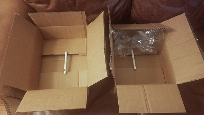 Two cardboard boxes with one pen each, highlighting a facepalm-worthy packaging fail due to excessive box size.