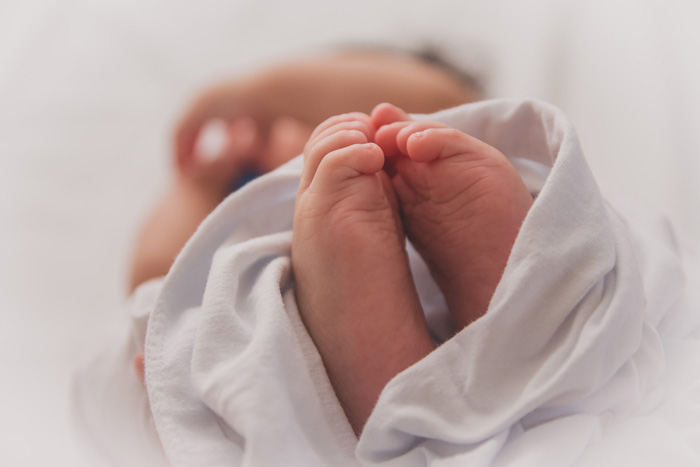 Close-up of baby's feet wrapped in soft fabric, illustrating unusual moments tied to weird Guinness World Records.