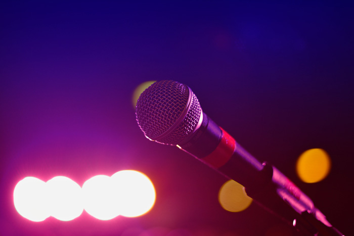 Microphone on stage with colorful lights in the background, highlighting weird Guinness World Records event setup.
