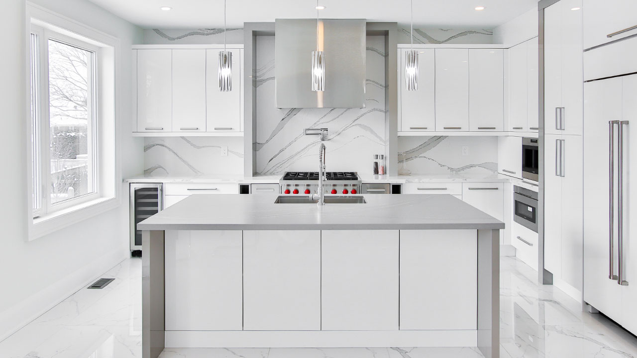 Modern bright kitchen featuring sleek white kitchen cabinets and a large island with a minimalist design. Modern bright kitchen featuring sleek white kitchen cabinets and a large island with a minimalist design.