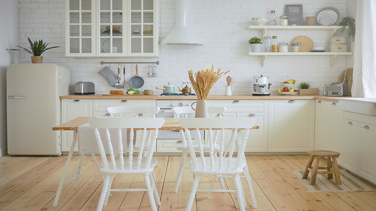 Farmhouse style kitchen featuring white kitchen cabinets, wooden countertops, and a rustic dining table with chairs. Farmhouse style kitchen featuring white kitchen cabinets, wooden countertops, and a rustic dining table with chairs.