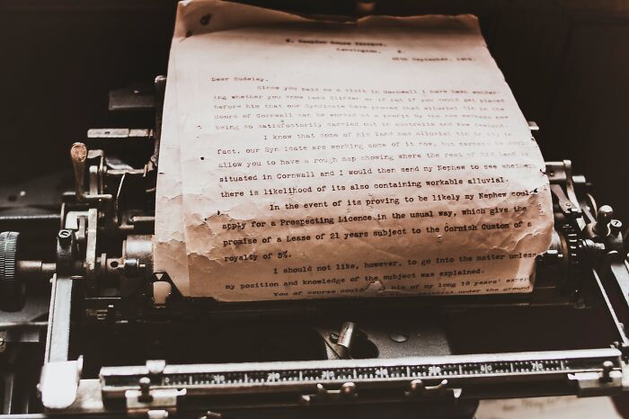 Old typewriter with a worn page showing a typed letter, symbolizing weird surprises people found after moving.