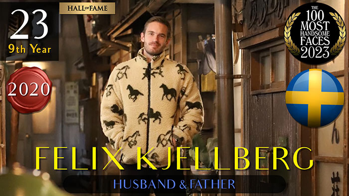 Man in patterned jacket standing in an urban setting, featured in the 2023 most handsome men list.