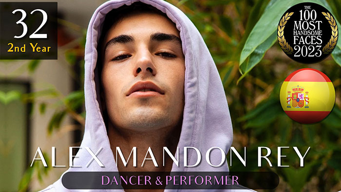 Handsome men 2023: A dancer and performer in a white hoodie, amidst green foliage background, ranked by 'The Independent Critics'.