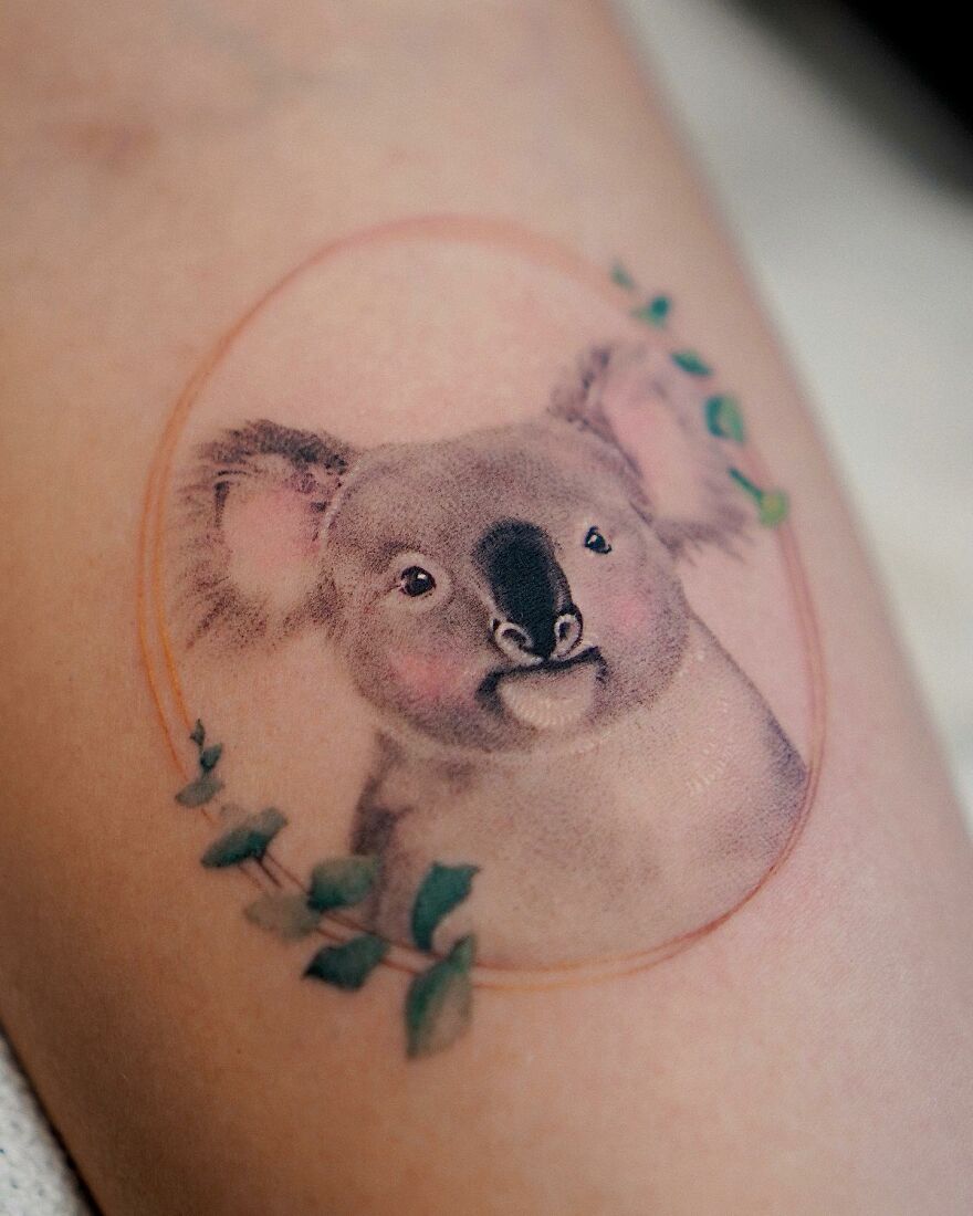 Painting-like tattoo of a koala with nature elements by a Korean ink artist.