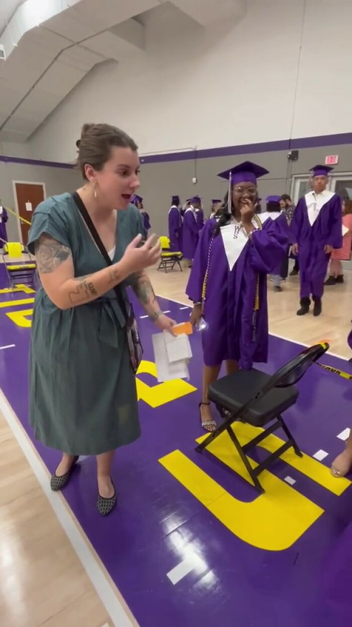 Teacher and student share an emotional moment at graduation, celebrating meaningful handwritten notes.