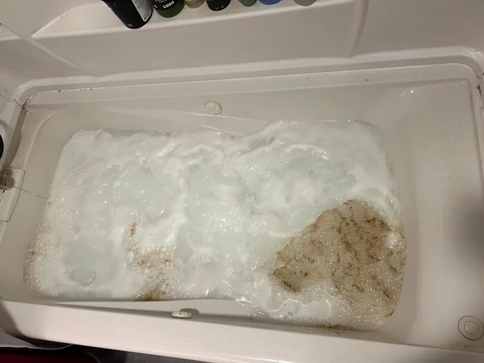 Bathtub with cleaning bubbles and residue, demonstrating a fresh start in cleaning techniques.