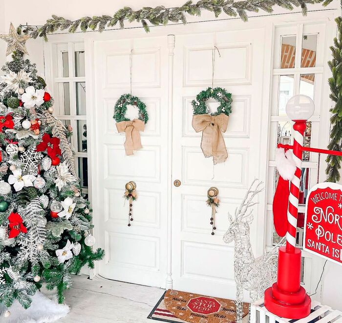 Christmas tree near door with two wreaths and affordable Christmas decor ideas for a festive and budget-friendly holiday setup.