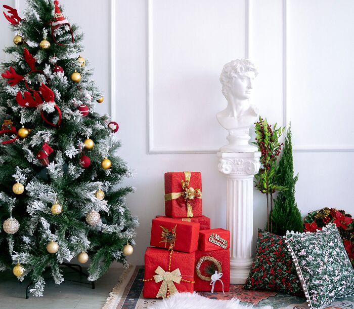 Christmas tree with affordable decor ideas and wrapped gift boxes in a cozy room setting for holiday celebration.