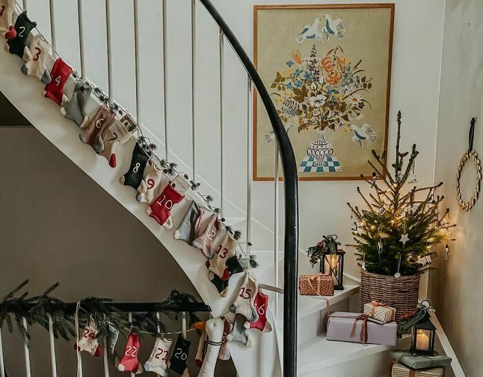 Advent calendar hanging on stairs with cozy Christmas decor showcasing affordable Christmas decor ideas for 2024.