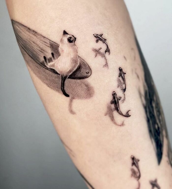 A Stylish Siamese Cat Leisurely Surfing In The Sea With Sharks