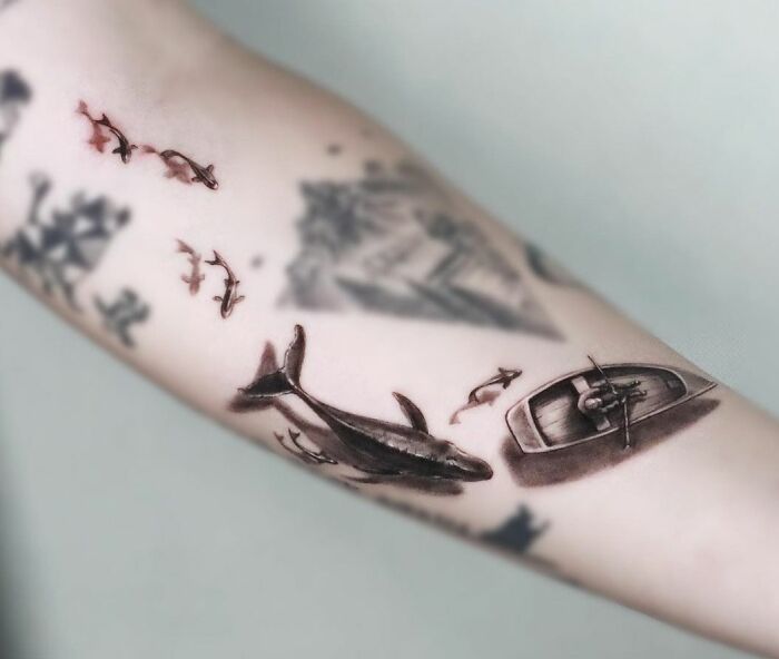 3D tattoo featuring a whale and boat on arm, showcasing tattoo artists' skill level.