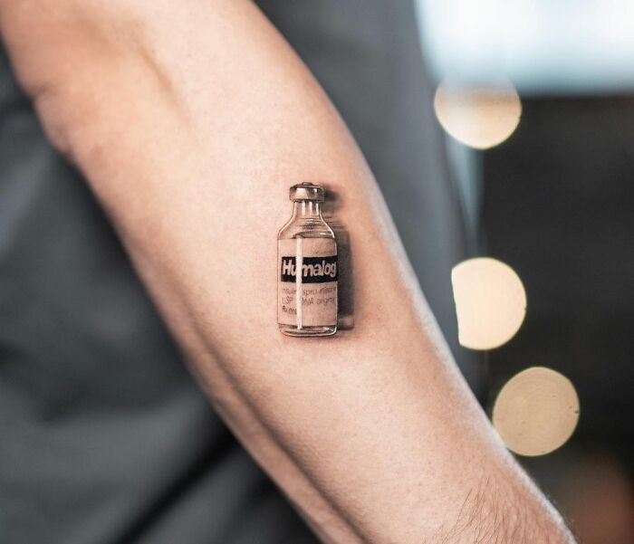 3D tattoo of a small vial on an arm, showcasing realistic detail and shading.