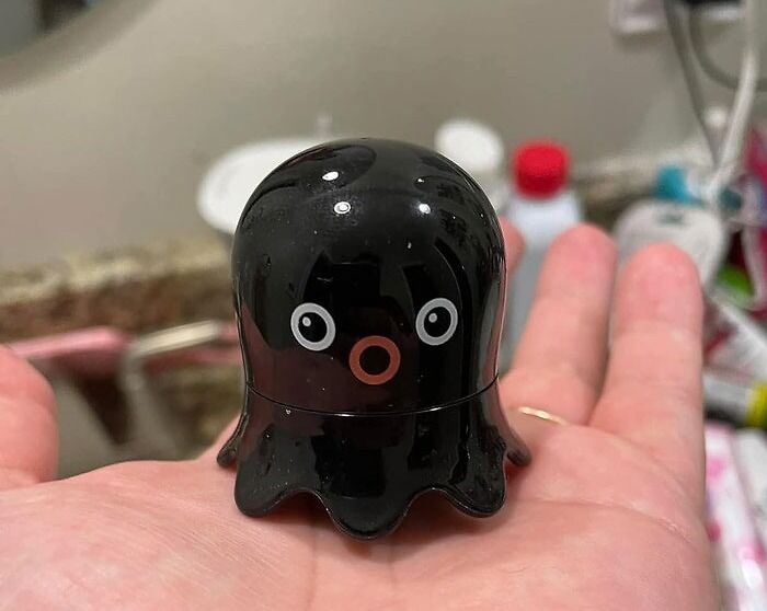 Black octopus-shaped toy on a hand, perfect for a last-minute Christmas gift with Amazon Prime.