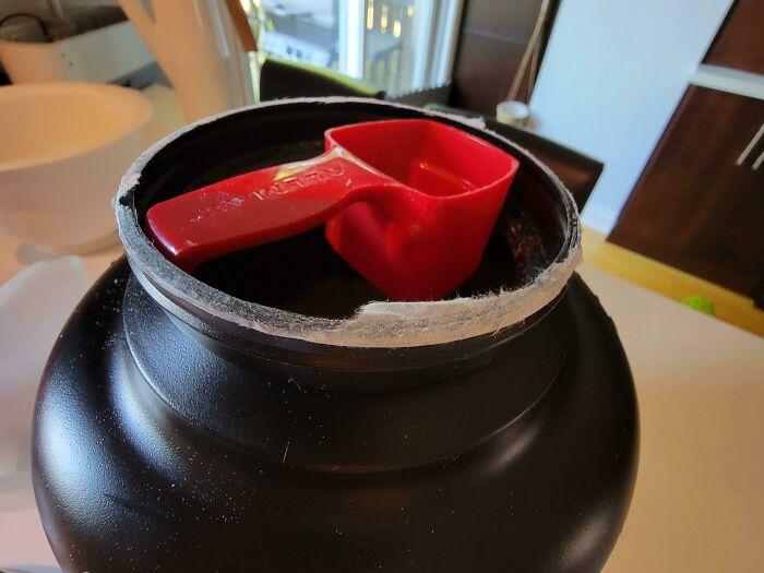 My Protein Powder Scoop Is Designed To Sit On A Lip Just Under The Lid... So You Don't Have To Reach Into The Powder To Grab It