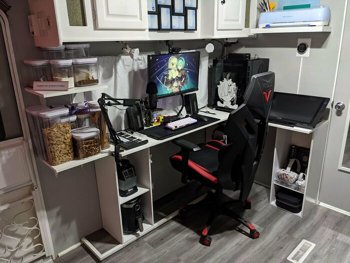 Cozy home office setup with gaming chair, dual monitors, organized shelves, and neat desk for productivity and comfort