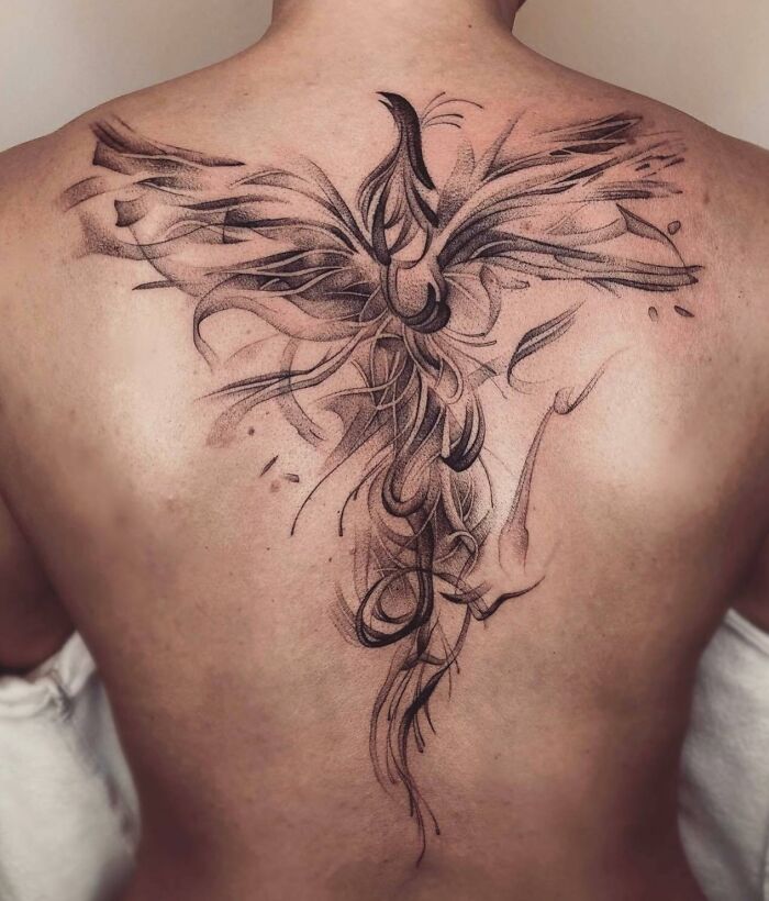 Abstract spine tattoo design with intricate black ink strokes.