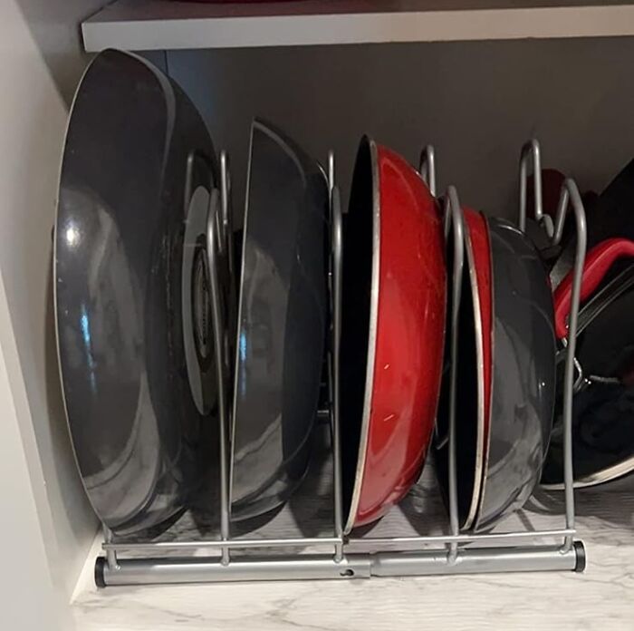 Pots and pans organized neatly in a rack to declutter and organize your home efficiently.