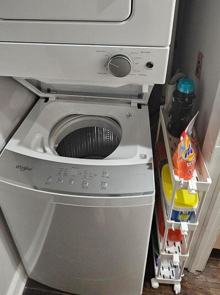 Compact laundry setup with stacked washer, dryer, and storage shelves to declutter and organise your home.