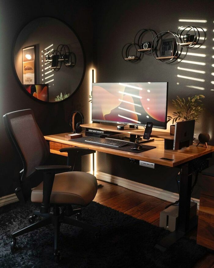 Cozy home office design with wooden desk, ergonomic chair, curved monitor, and warm ambient lighting creating a productive workspace.