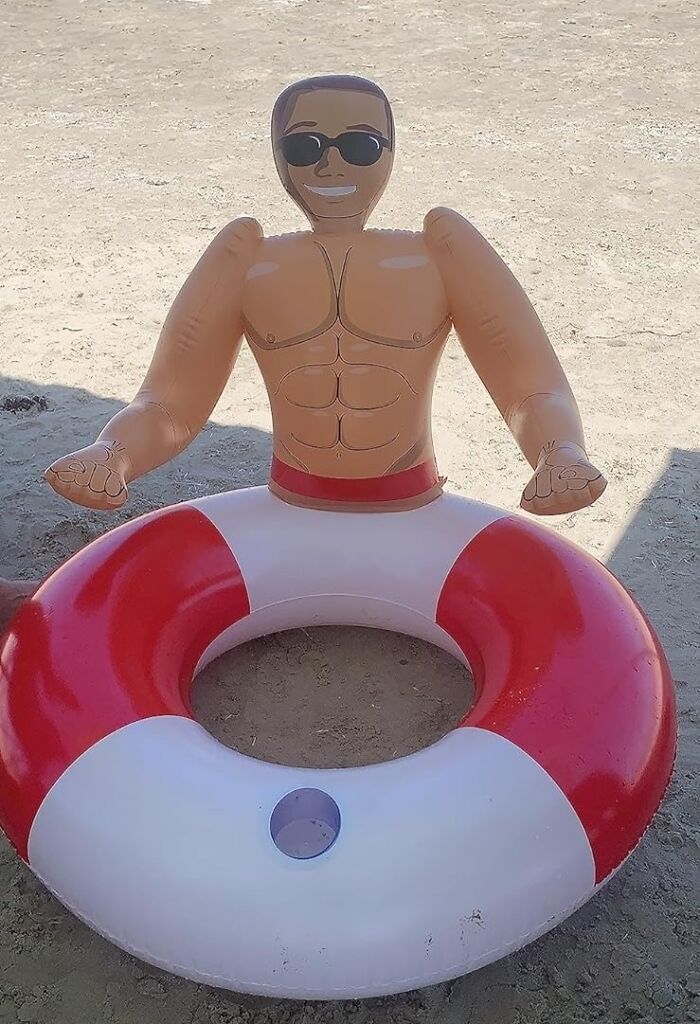 Inflatable funny product on a beach, designed as a muscular man with sunglasses, perfect for humor in 2024.