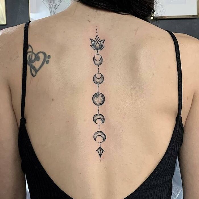 Moon phase spine tattoo design, featuring detailed dot work.
