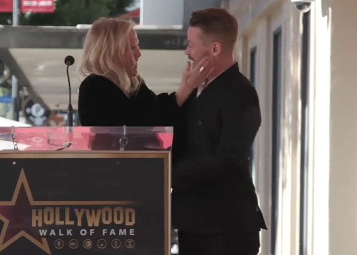 Catherine O'Hara at Hollywood Walk of Fame ceremony, interacting warmly with a man on stage.