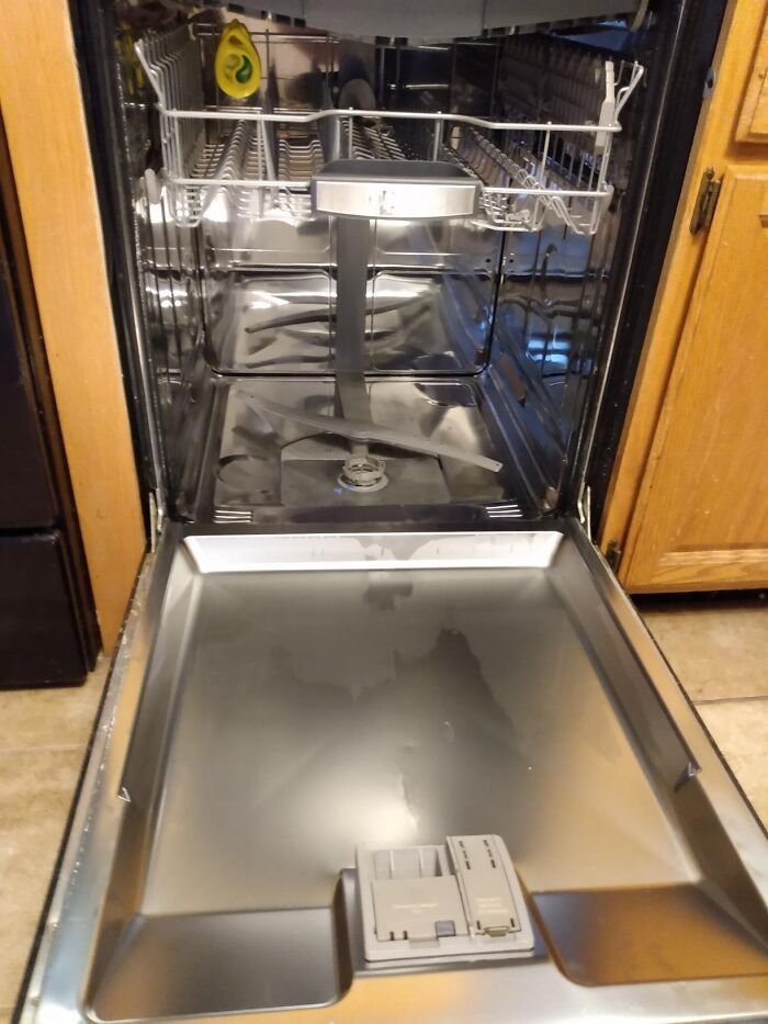 Open and clean dishwasher ready for Operation Fresh Start, highlighting spotless interior for efficient cleaning.