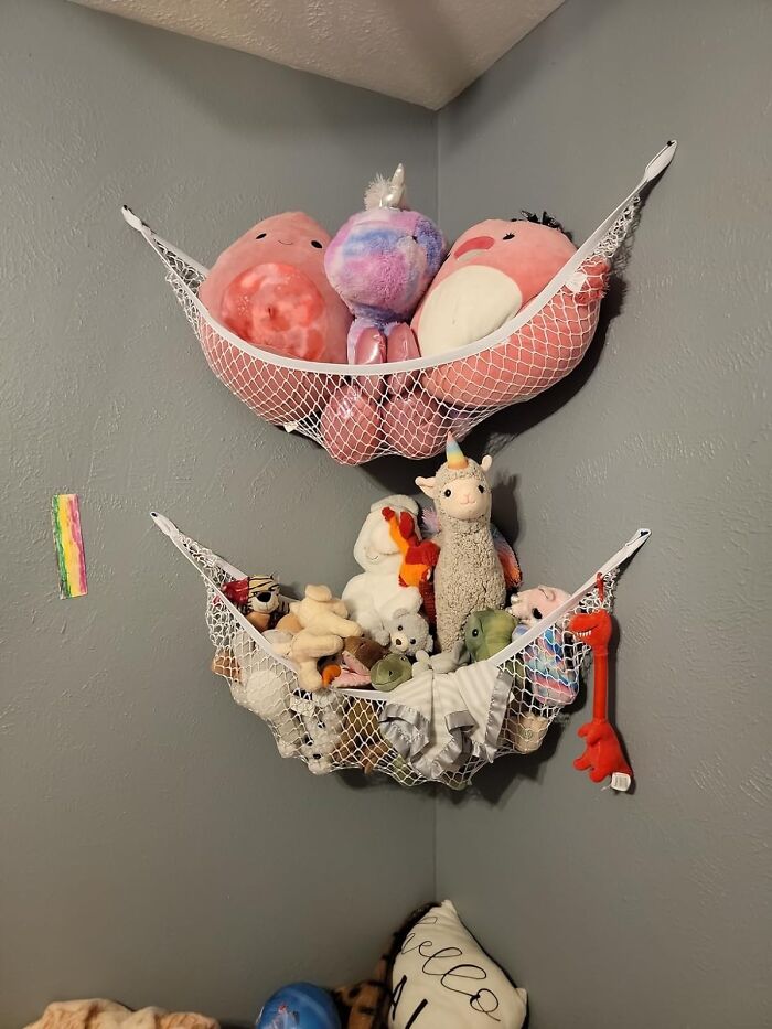 Mesh hammock shelves holding stuffed animals, a product to declutter and organize your home.