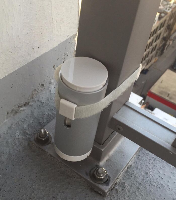 Unique gift idea: a compact, cylindrical gadget securely fastened to a balcony railing.