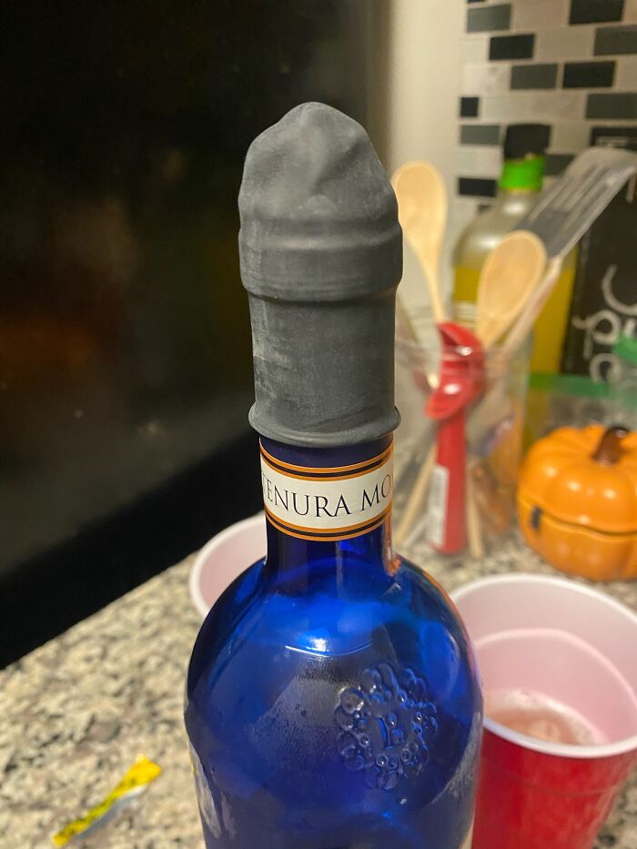 Funny product: novelty wine bottle stopper shaped like a phallic symbol, adding humor to kitchen decor.
