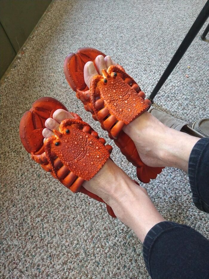 Funny crab-shaped slippers on a person's feet, adding humor to everyday life.