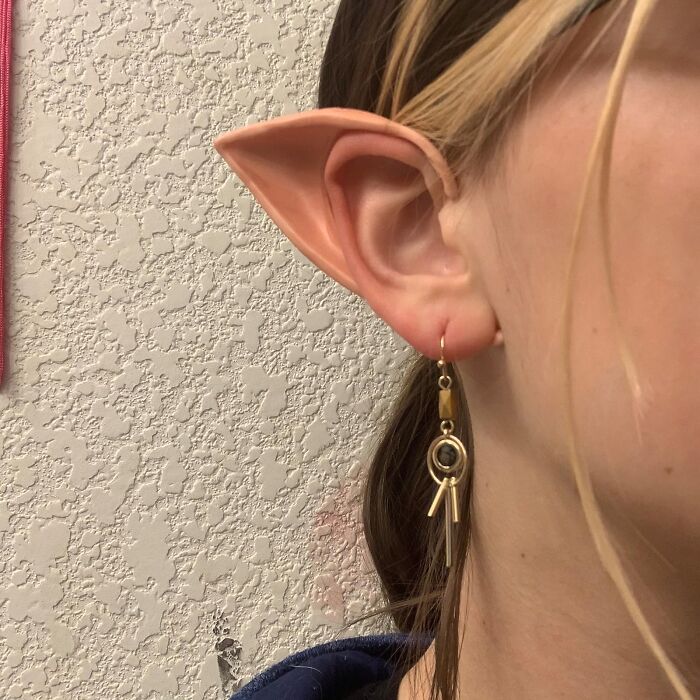 Earpiece shaped like elf ears with a quirky earring, for a funny 2024.