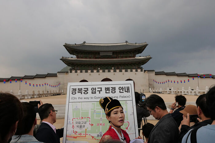 Tourists capturing urban magic at Gyeongbokgung Palace during the 36th AAP Magazine Photography Awards event.
