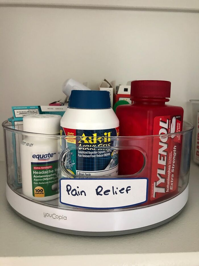 Organise your home with labeled medicine storage, featuring pain relief products like Advil and Tylenol in a clear container.