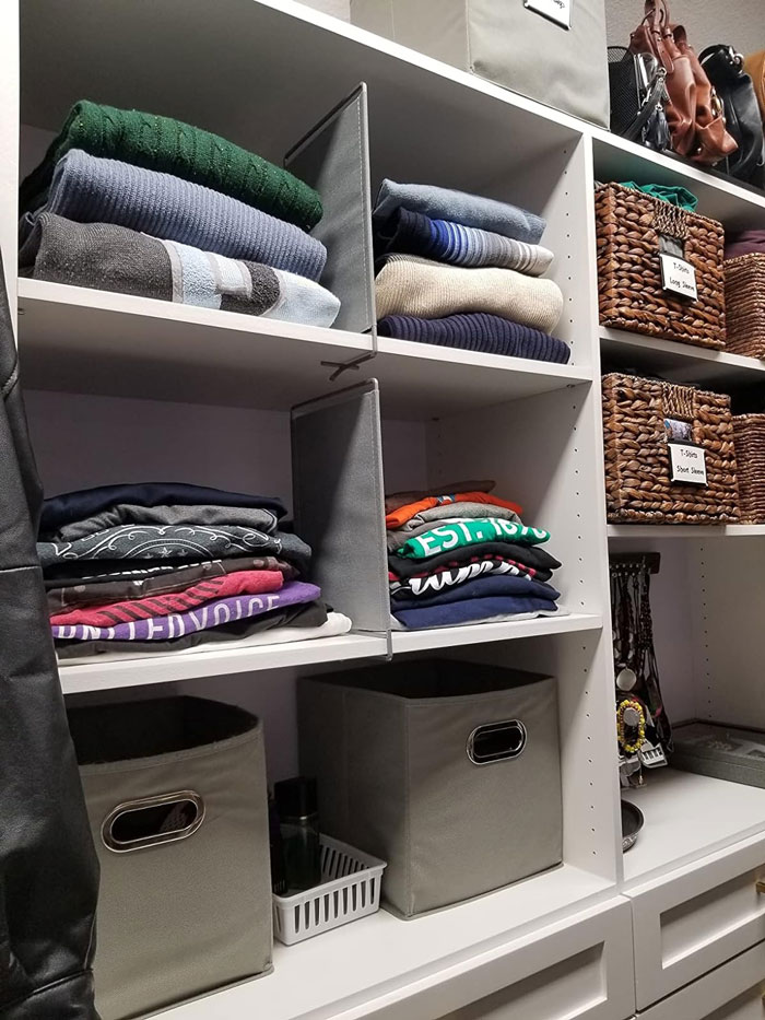 Closet with neatly folded clothes, storage bins, and woven baskets to declutter and organize your home.